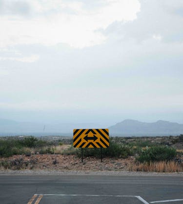 Photo of a sign with two arrow representing how to choose the best customer training software for your business